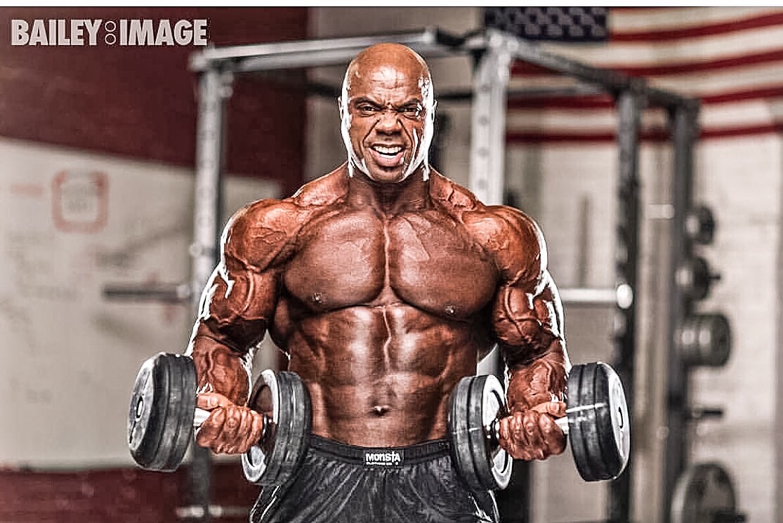 Toney Freeman training with heavy dumbbells in a gym
