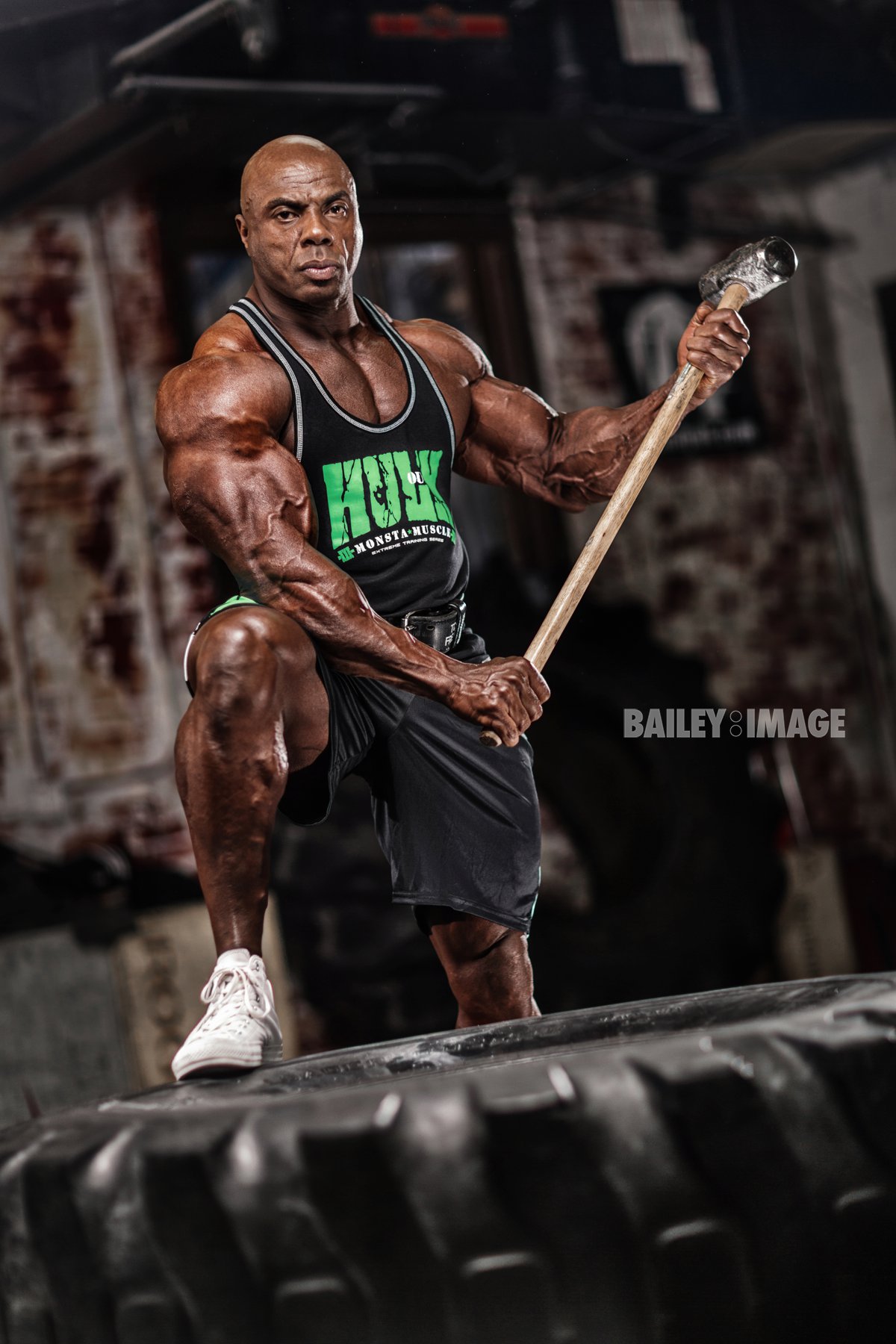 Toney Freeman braced on a training tire with a sledgehammer in hand